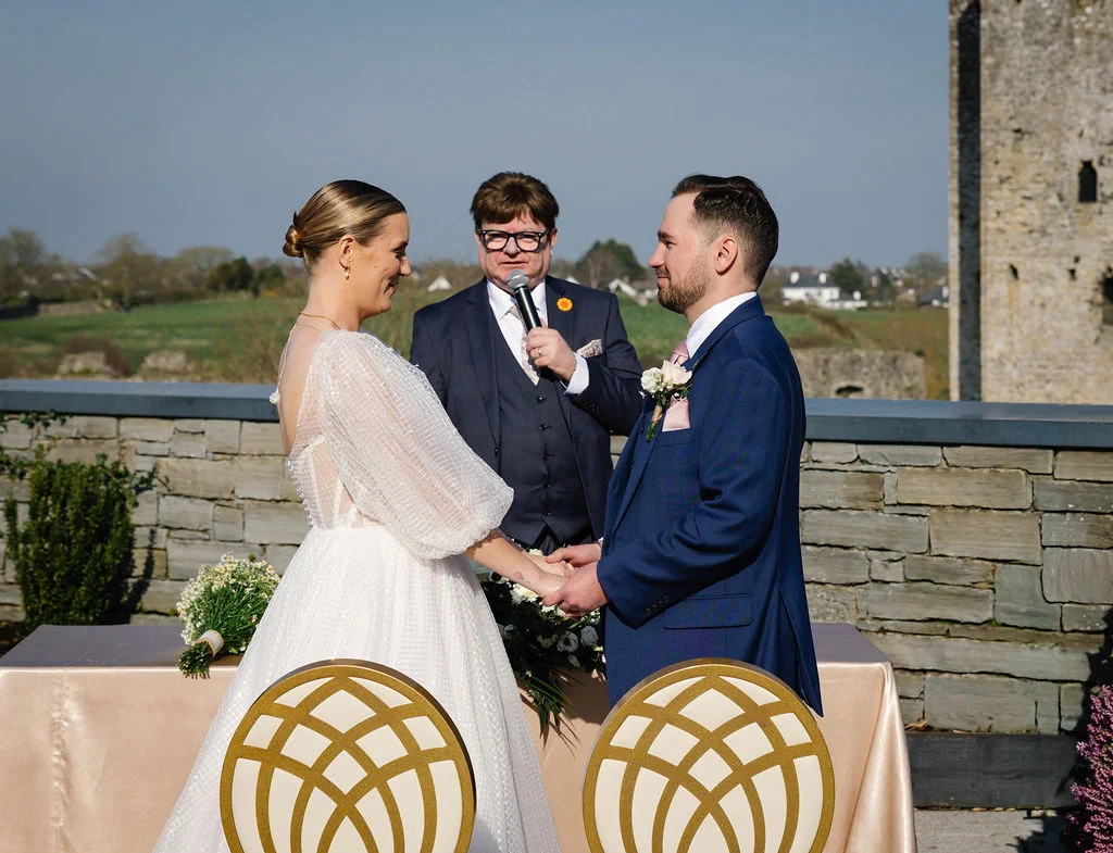 Celebrant conducting an outdoor wedding ceremony for a couple