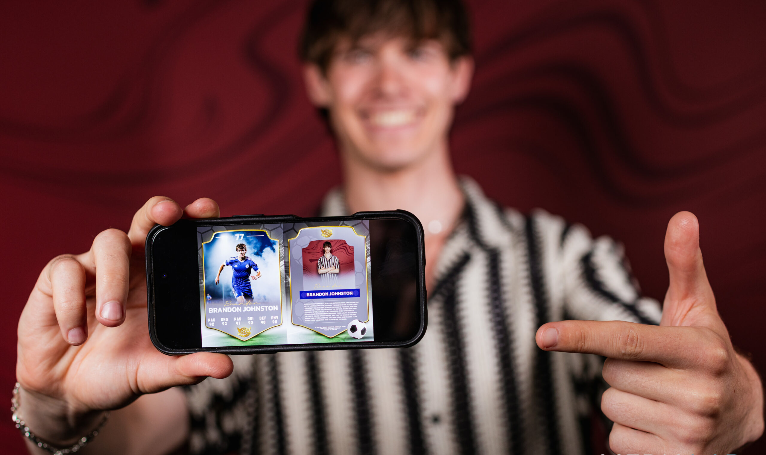 Man showing two digital photo booth cards on his phone at an event