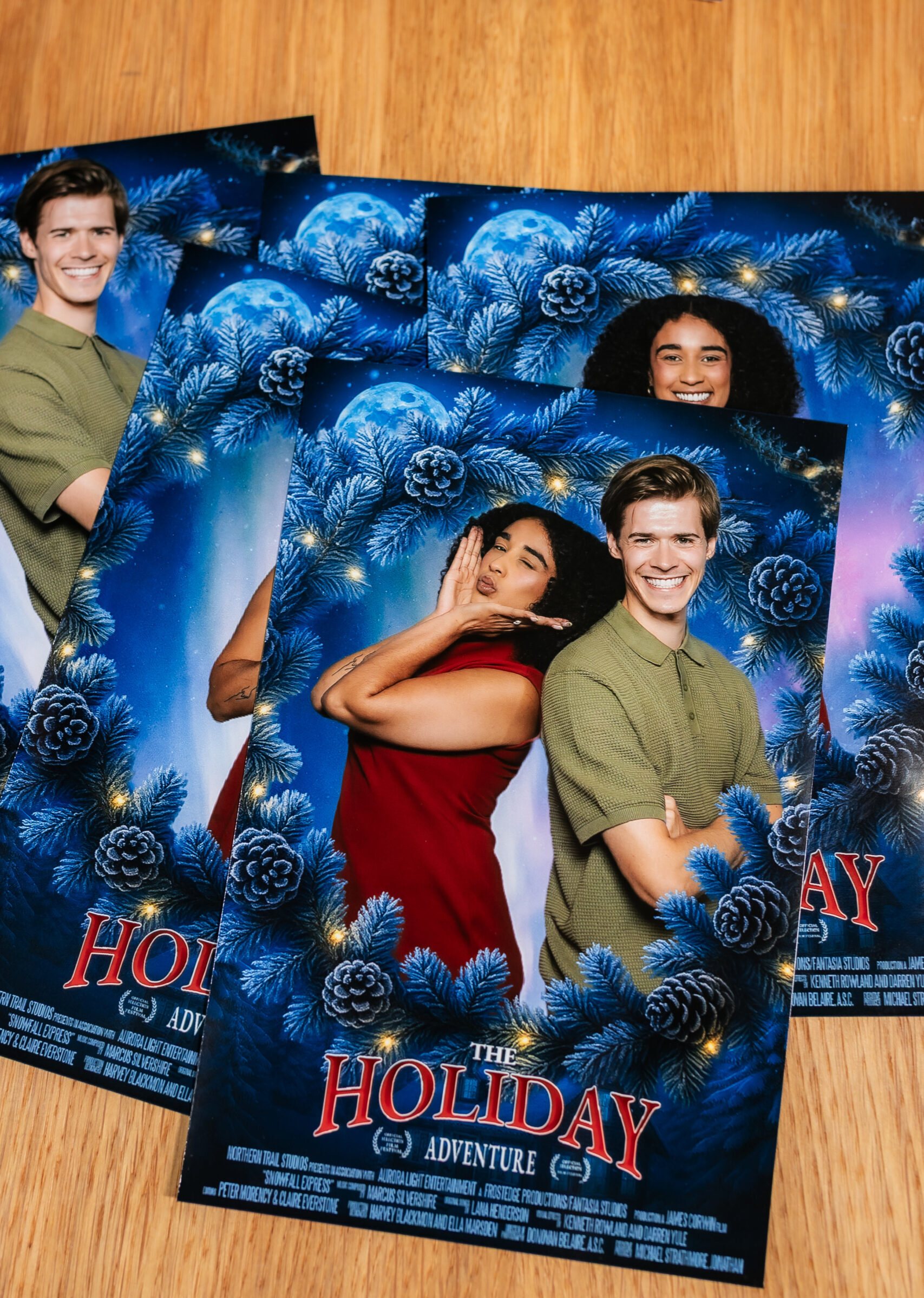 Printed photo booth cards with a floral holiday design on a table