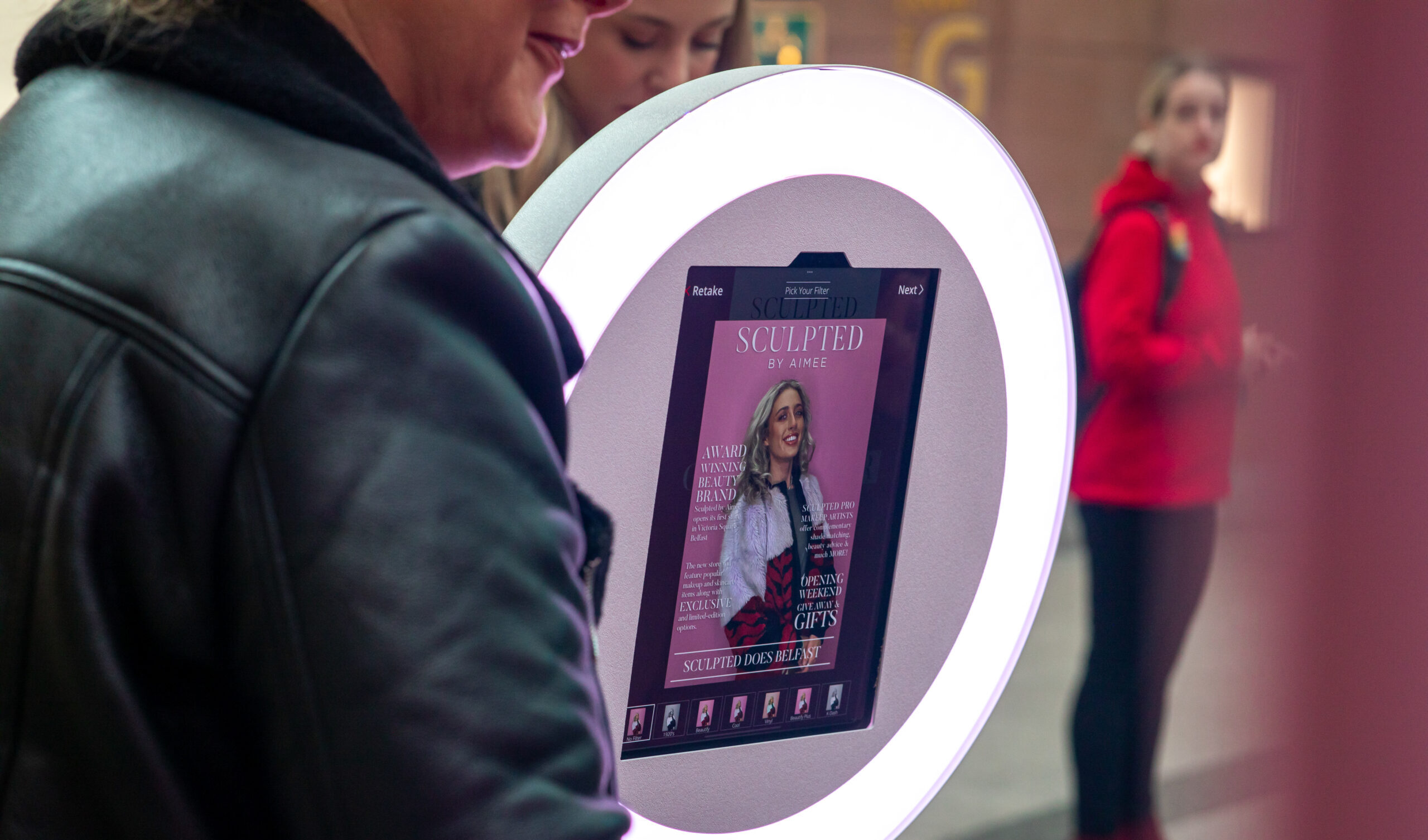 Close-up of a branded ring light photo booth screen at a retail event