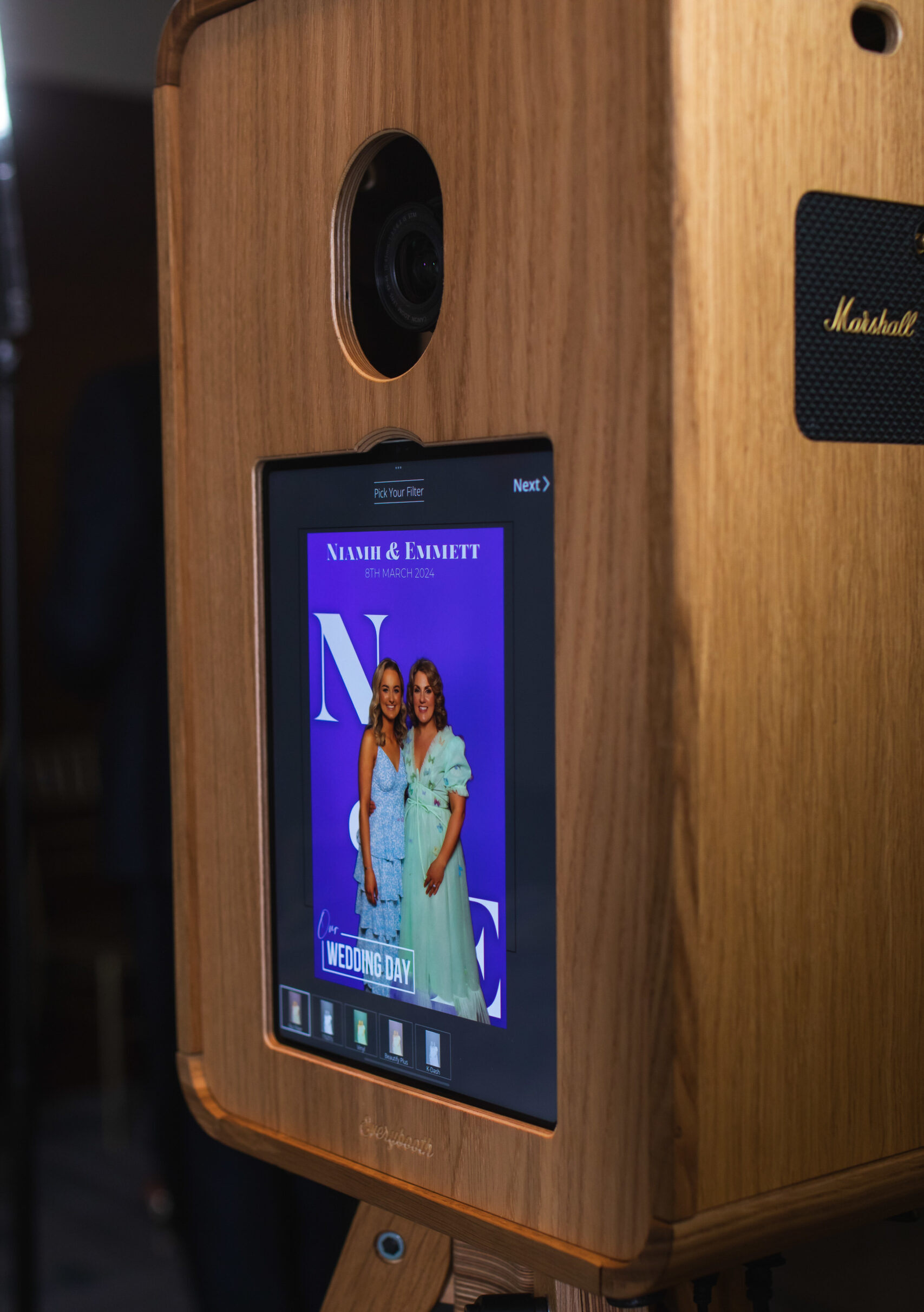 Wooden photo booth screen displaying a couple's wedding photo