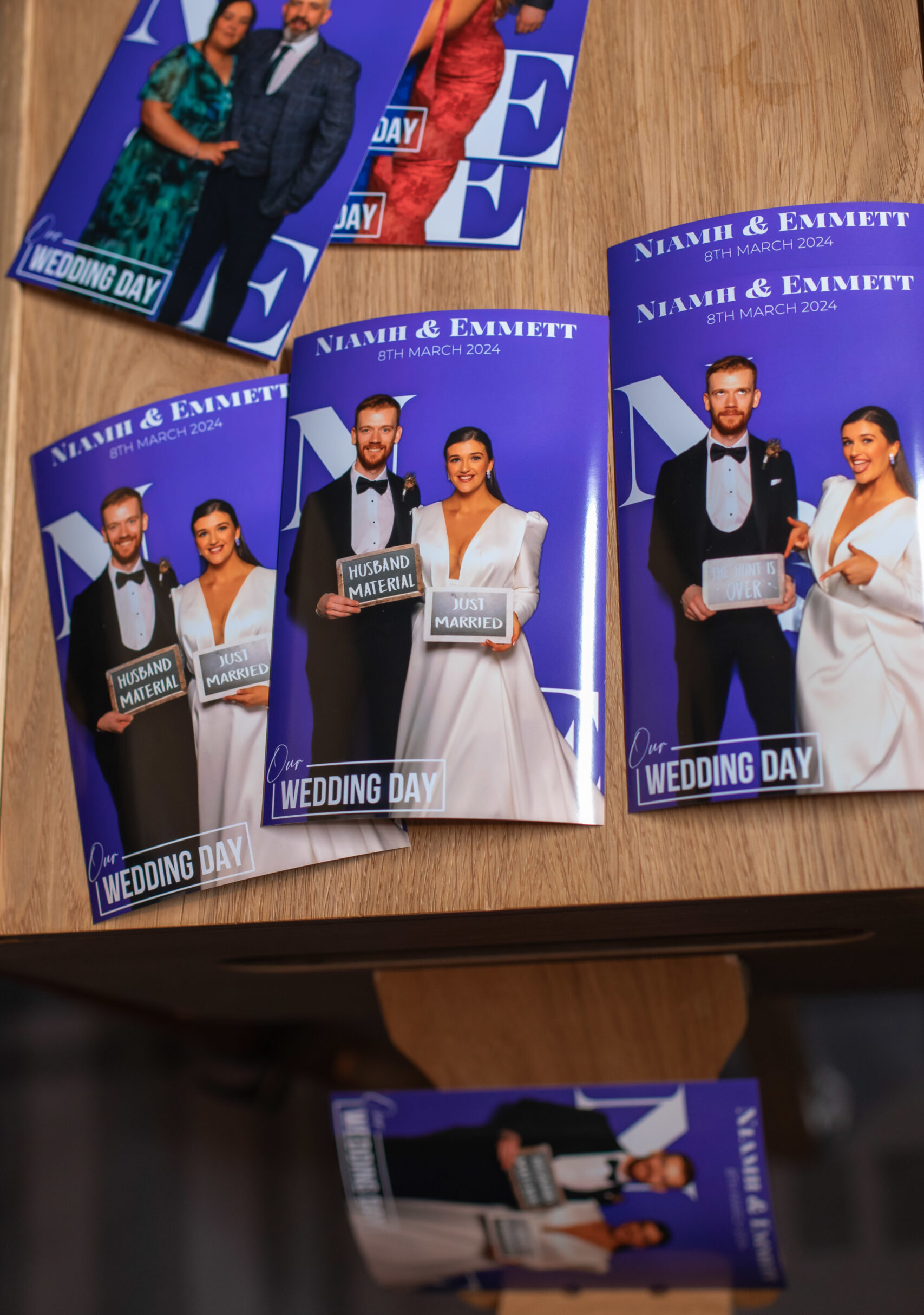 Stack of personalised wedding photo booth prints on a table