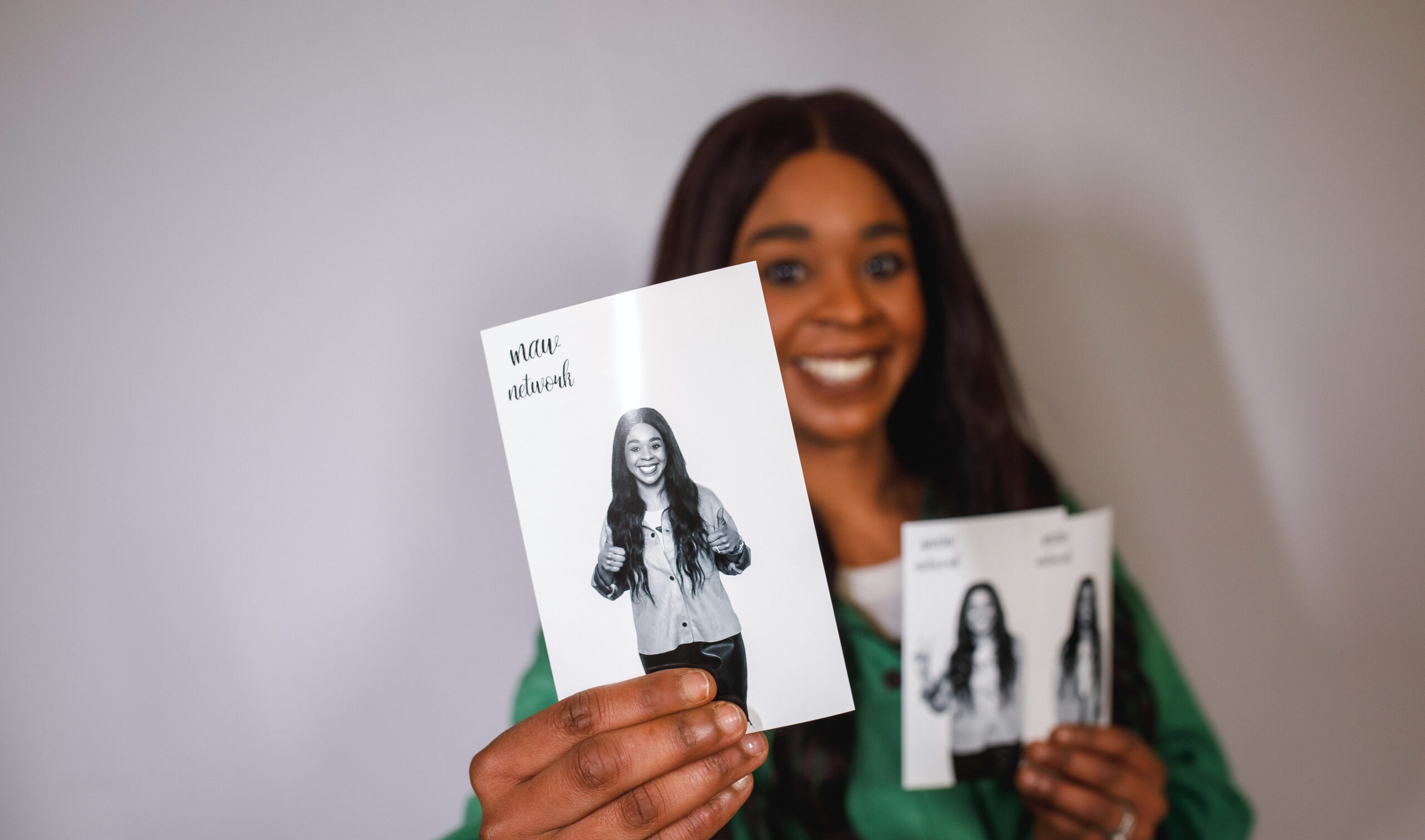 Woman holding a black and white photo booth print at an event