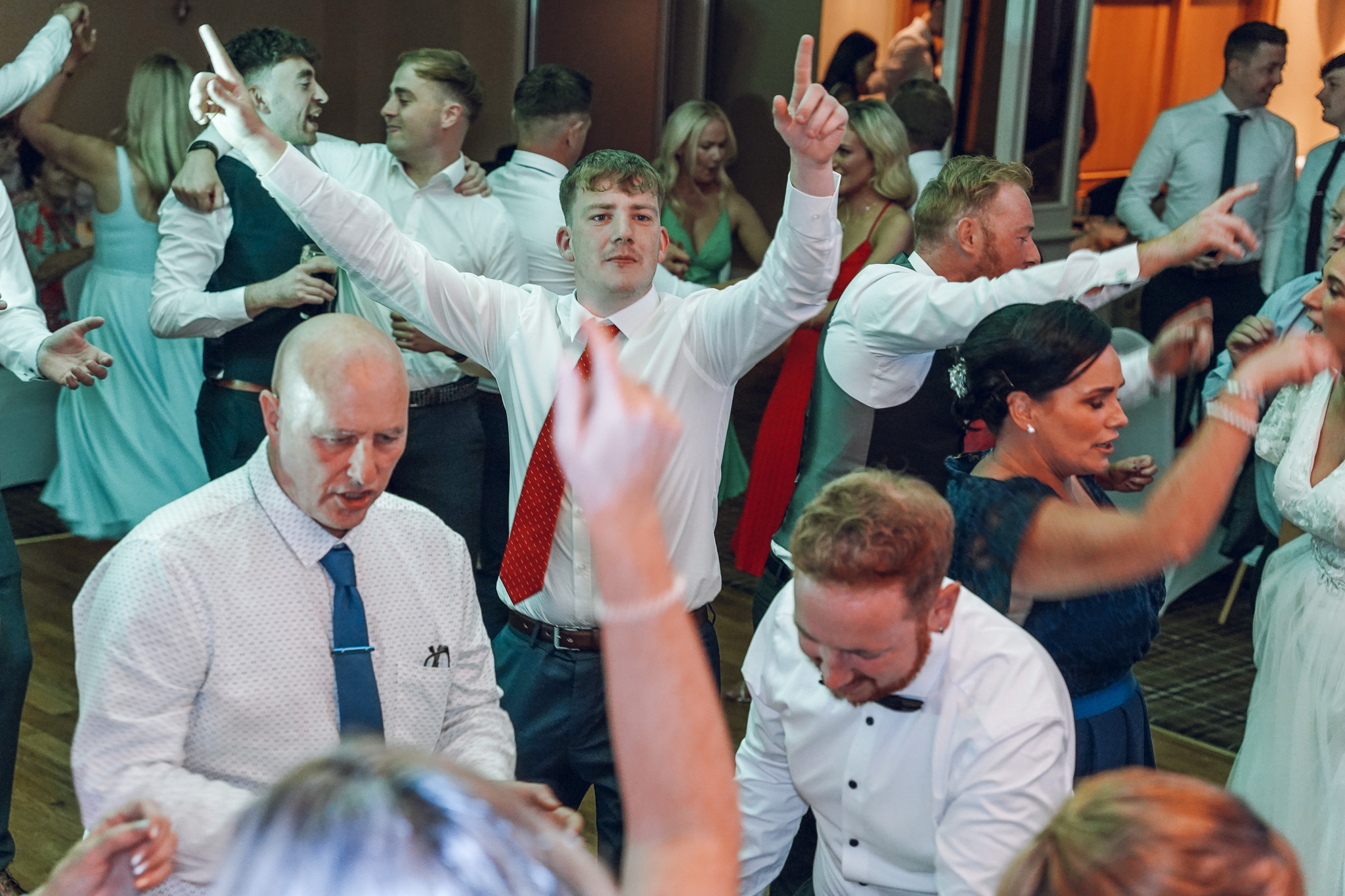 Group of wedding guests dancing and having fun